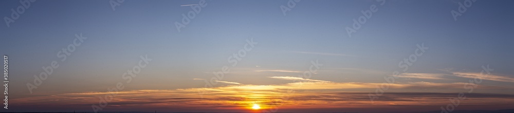 Picture of dramatic and colorful sky with sun during sunset Picture of dramatic and colorful sky with sun during sunset