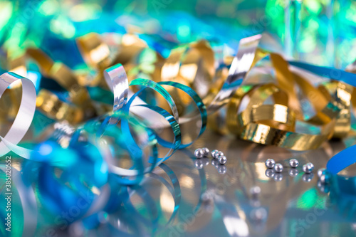 Detailed photo of colorful champagne glasses with pearls, glitter, ribbons and ornaments. Selective focus - extremely shallow depth of field.