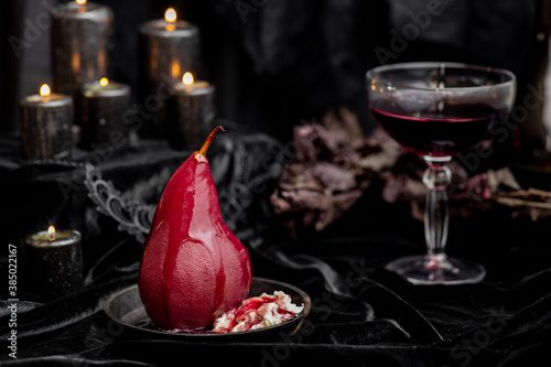Red wine poached bloody gothic Halloween pears with cream, wine & candles