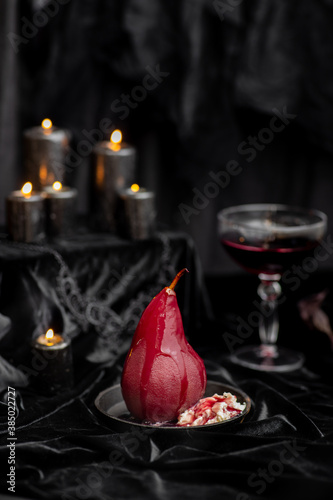 Red wine poached bloody gothic Halloween pears with cream, wine & candles