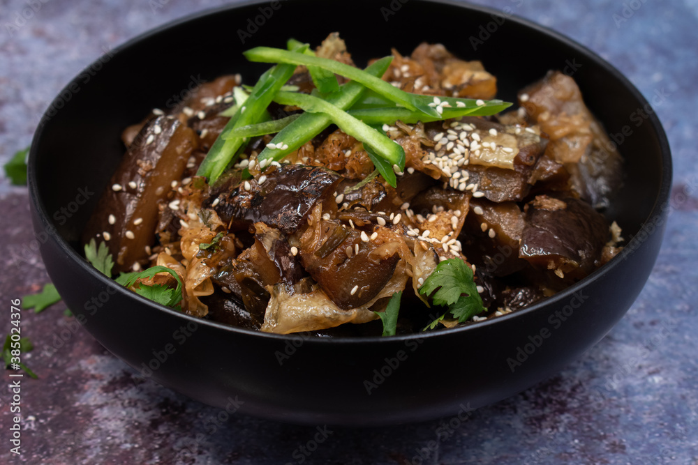 Korean vegan braised eggplant gaji namul served in dark bowl Korean vegan braised eggplant gaji namul served in dark bowl