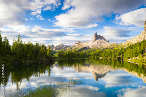 Clouds over Becco di Mezzodi reflected in the blue water of Lake Federa at sunrise, Ampezzo Dolomites, Belluno, Veneto, Italy photo