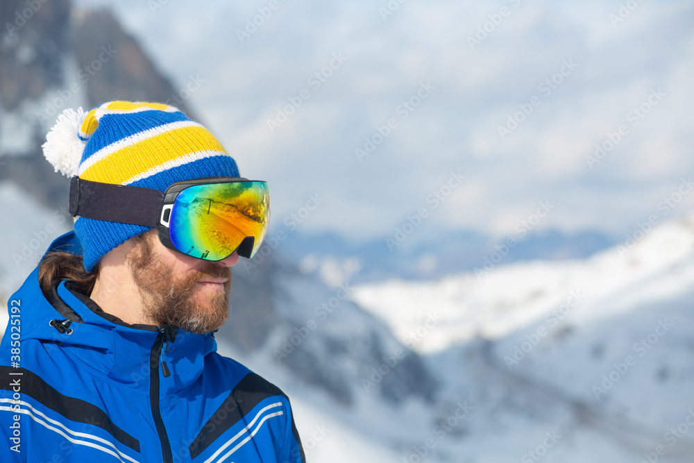 Skier in goggles look at mountains Skier in goggles look at mountains