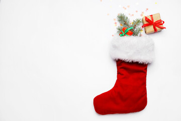 Christmas sock with gifts on white background