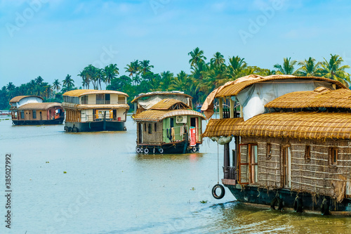 Kerala houseboats cruising Lake Vembanad, longest lake in India, during a backwater tour, Alappuzha (Alleppey), Kerala, India