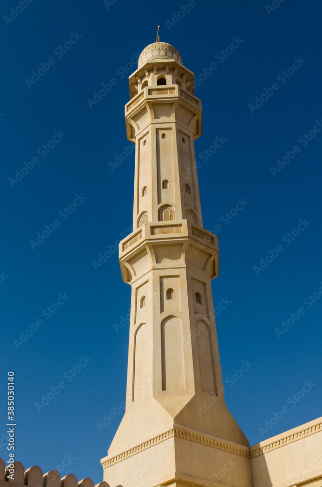 Minaret of the Mosque against a bright blue sky