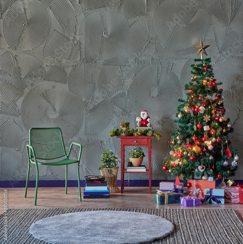 Christmas, New Year interior with grey stone wall background, decorated fir tree, green chair gift and red coffee table style. © UnitedPhotoStudio