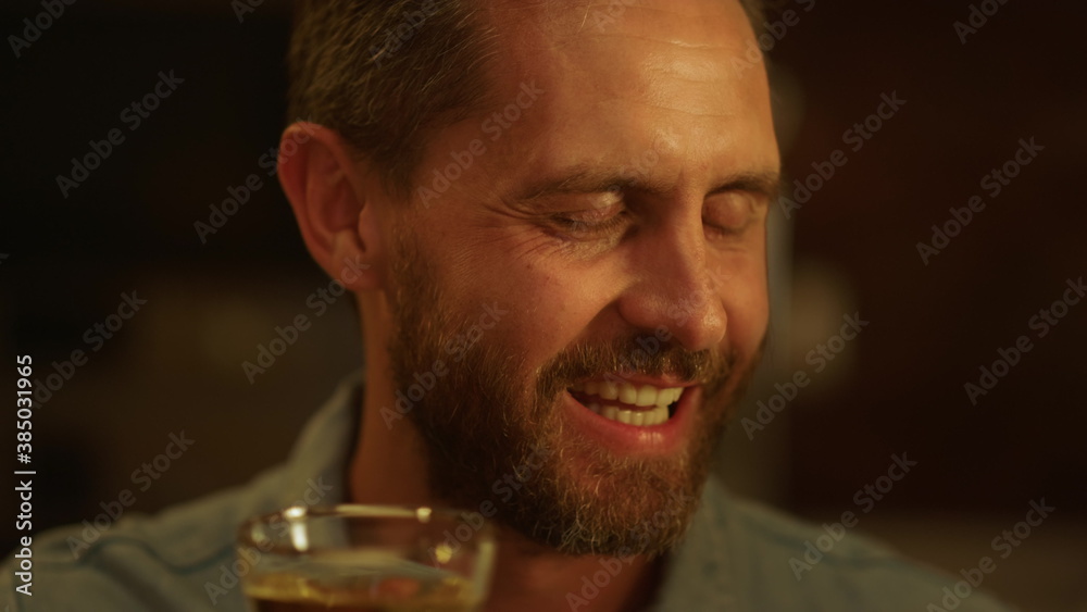 Handsome man making toast during dinner. Smiling guy talking with family Handsome man making toast during dinner. Smiling guy talking with family