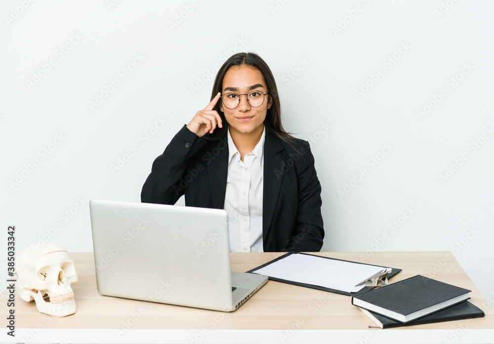 Young traumatologist asian woman isolated on white background pointing temple with finger, thinking, focused on a task. Young traumatologist asian woman isolated on white background pointing temple with finger, thinking, focused on a task.