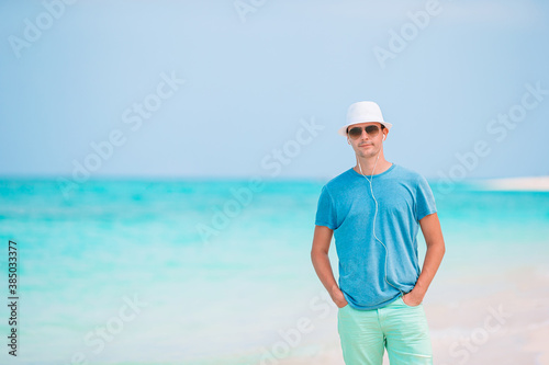 Young man on the white beach on vacation