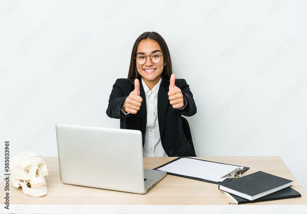 Young traumatologist asian woman isolated on white background with thumbs ups, cheers about something, support and respect concept. Young traumatologist asian woman isolated on white background with thumbs ups, cheers about something, support and respect concept.