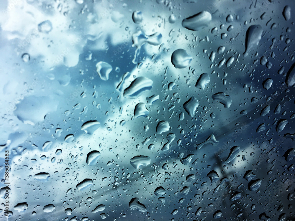 Water drops of rain on blue glass background Water drops of rain on blue glass background