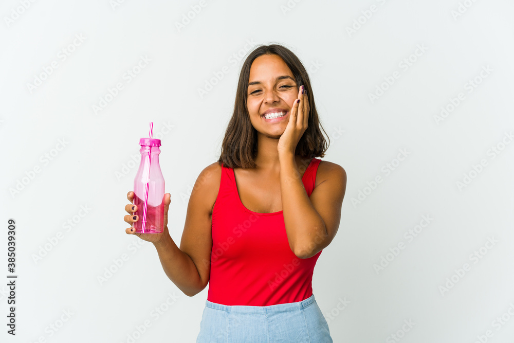 Young latin woman holding a milkshake isolated on white background Young latin woman holding a milkshake isolated on white background