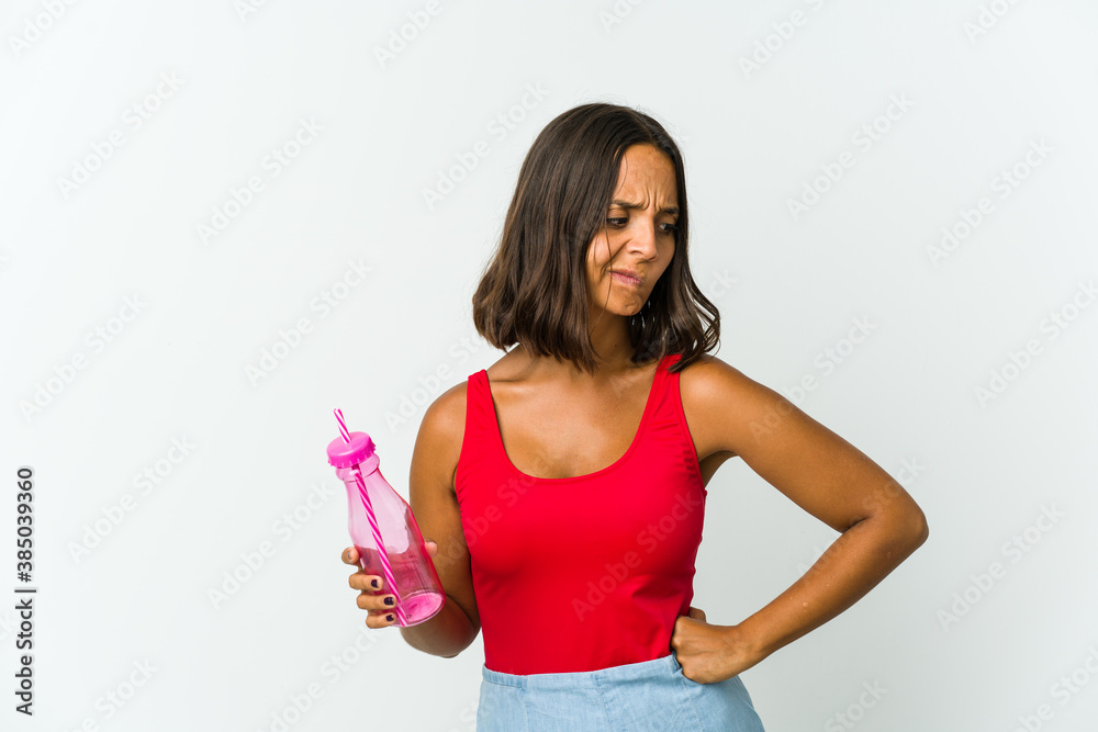 Young latin woman holding a milkshake isolated on white background Young latin woman holding a milkshake isolated on white background