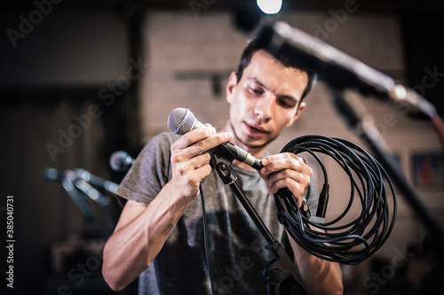 Obraz na plátně Theater audio technician adjusting an microphones on the scene