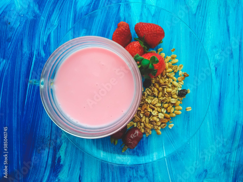 strawberry yogurt with fruits on blue textured background  photo