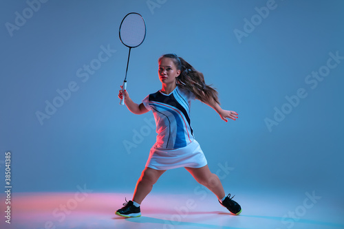 Energy. Beautiful dwarf woman practicing in badminton isolated on blue background in neon light. Lifestyle of inclusive people, diversity and equility. Sport, activity and movement. Copyspace. © master1305