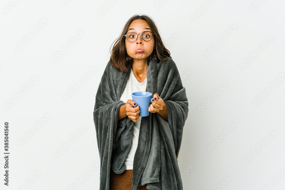 Young latin woman with blanket isolated on white background Young latin woman with blanket isolated on white background
