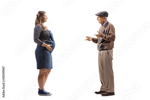 Full length profile shot of a pregnant woman and an elderly man having a conversation © Ljupco Smokovski