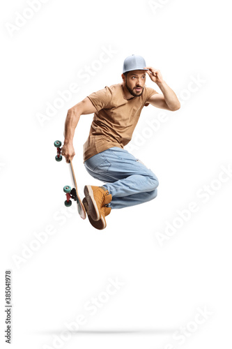 Full length shot of a skater performing a jump with a skateboard
