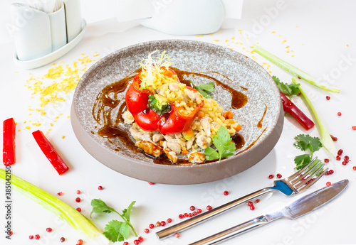 Chicken breast with bulgur baked in pepper in a gray ceramic plate in a restaurant. Selective focus. Super short focus photo