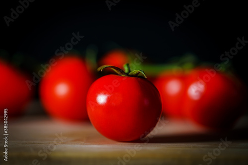 Close-up of tomato cherry on wooden board, selective focus