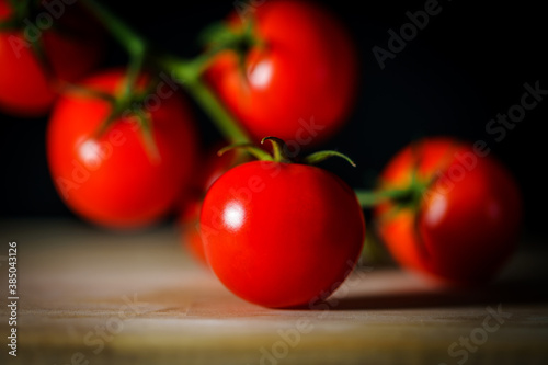 Close-up of tomato cherry on wooden board, selective focus