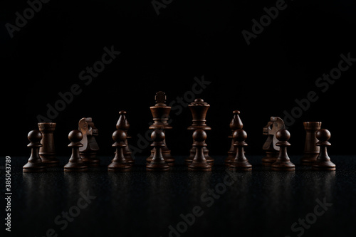 row of chess pieces on black background