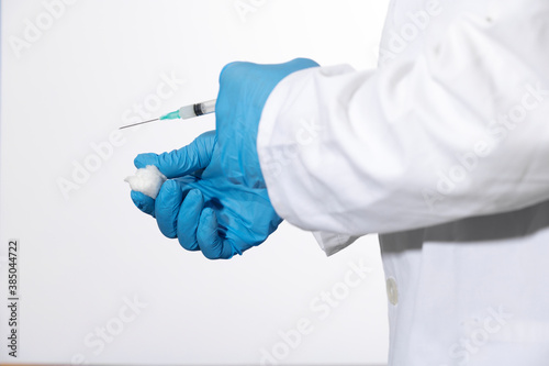 Doctor or nurse holding flu vaccine, syringe for measles injection prepares for baby and adult vaccination, medicine and drug concept, white background