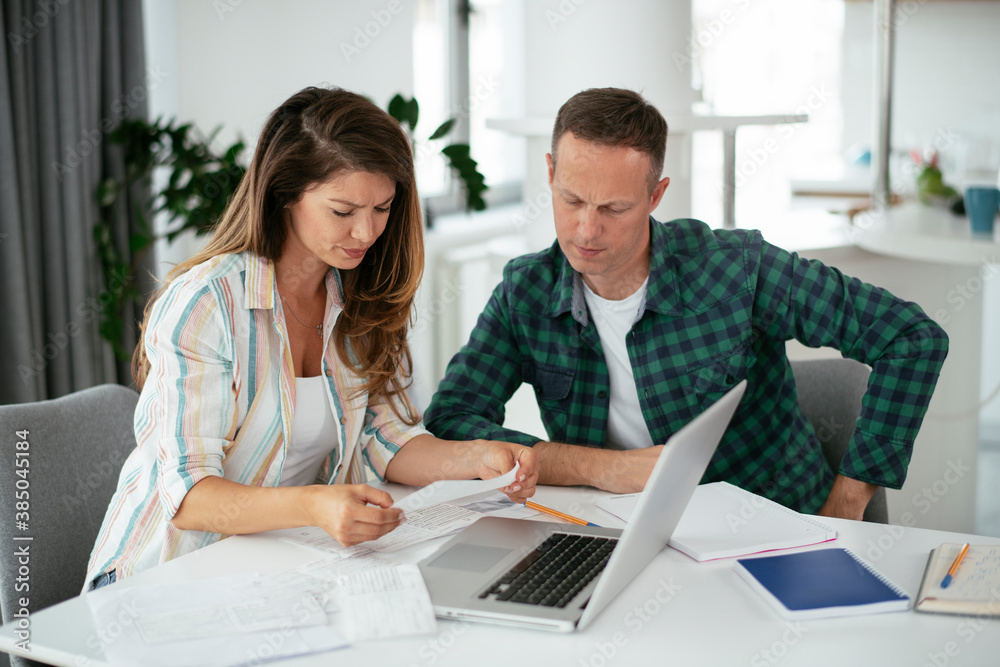 Husband and wife preparing bills to pay. Young couple having financial problems.. Husband and wife preparing bills to pay. Young couple having financial problems..