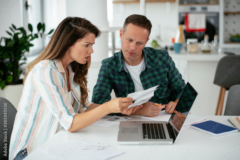 Husband and wife preparing bills to pay. Young couple having financial problems.. Husband and wife preparing bills to pay. Young couple having financial problems..