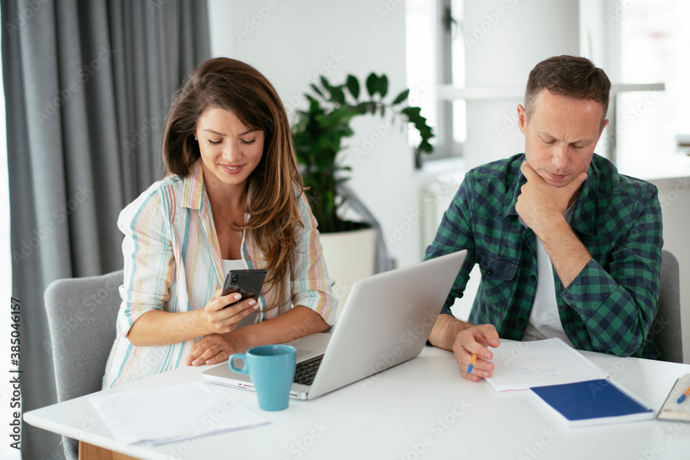 Husband and wife preparing bills to pay. Young couple having financial problems.. Husband and wife preparing bills to pay. Young couple having financial problems..