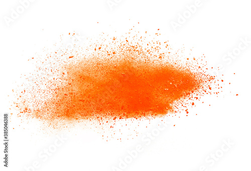 Orange powder explosion isolated on white background.