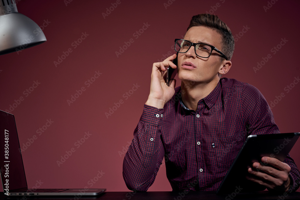 Business man in office and talking on the phone manager red background model cropped view of laptop tablet Business man in office and talking on the phone manager red background model cropped view of laptop tablet