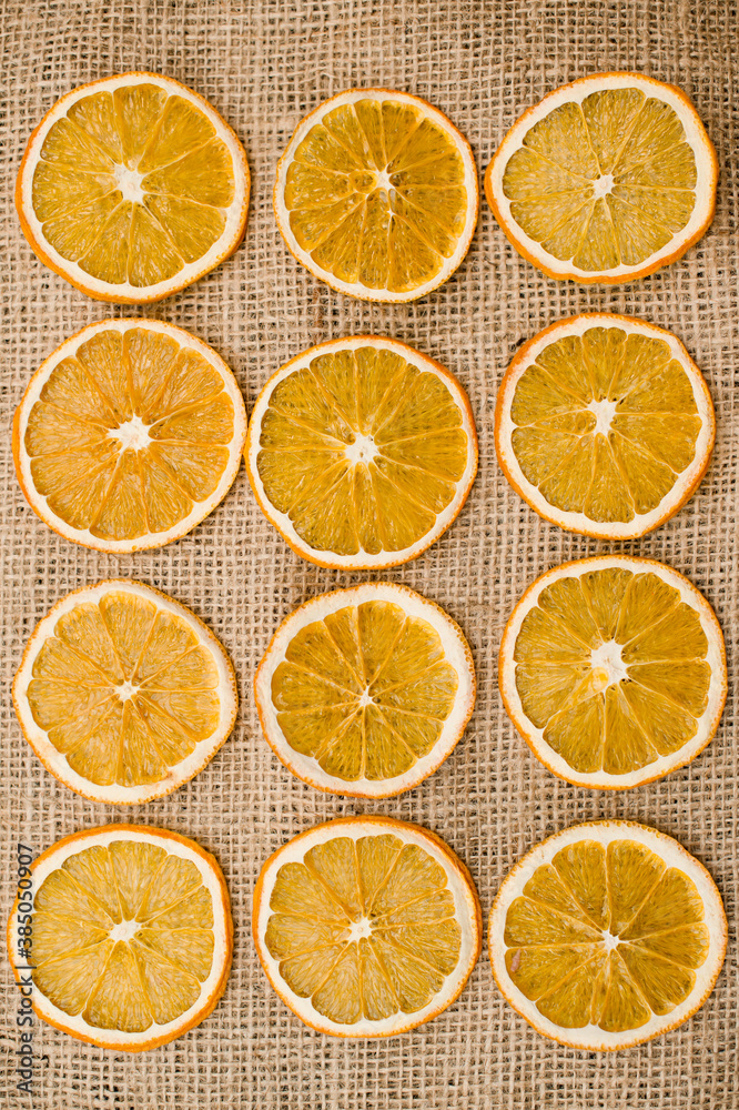 Dried Orange slices on linen cloth. Christmas decoration. Advent ornaments. Ethnographic ornamentation background