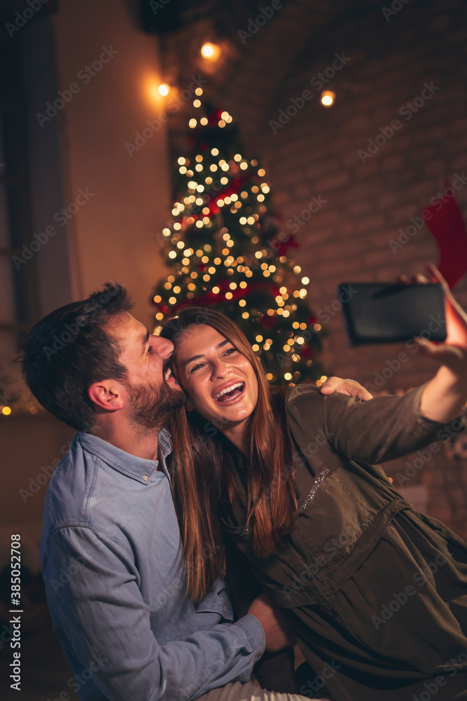 Couple taking a selfie on Christmas Eve