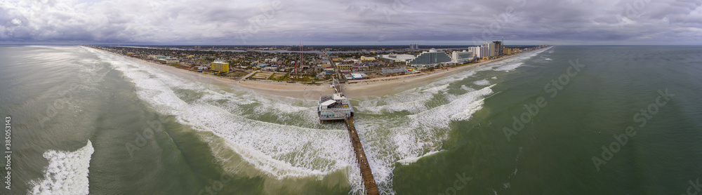 Daytona Beach Main Street Pier, Joe's Crab Shack and Joyland Amusement center panorama aerial view in a cloudy day, Daytona Beach, Florida FL, USA. Daytona Beach Main Street Pier, Joe's Crab Shack and Joyland Amusement center panorama aerial view in a cloudy day, Daytona Beach, Florida FL, USA.