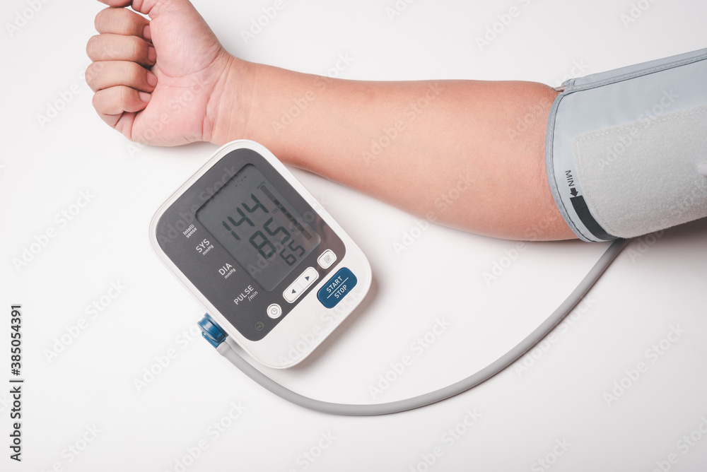 man hand using digital pressure gauge check his blood pressure , digital number showing hypertension result man hand using digital pressure gauge check his blood pressure , digital number showing hypertension result
