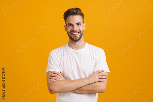 Joyful handsome guy smiling and looking at camera