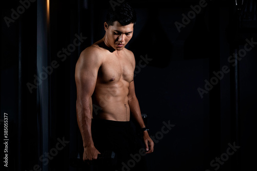 Fitness asian man exercise training warm up body and posing in gym,Healthy lifestyle.