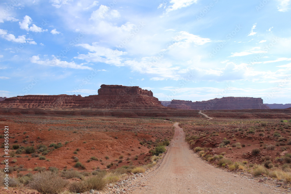 Scenic drive with a gorgeous southwest desert landscape featuring canyons and sandstone buttes in Valley of the Gods, Utah
