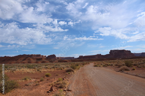 Scenic drive with a gorgeous southwest desert landscape featuring canyons and sandstone buttes in Valley of the Gods, Utah