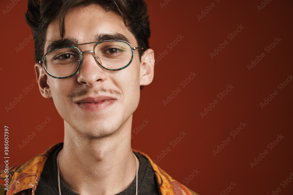 Smiling young hipster teenager with large glasses