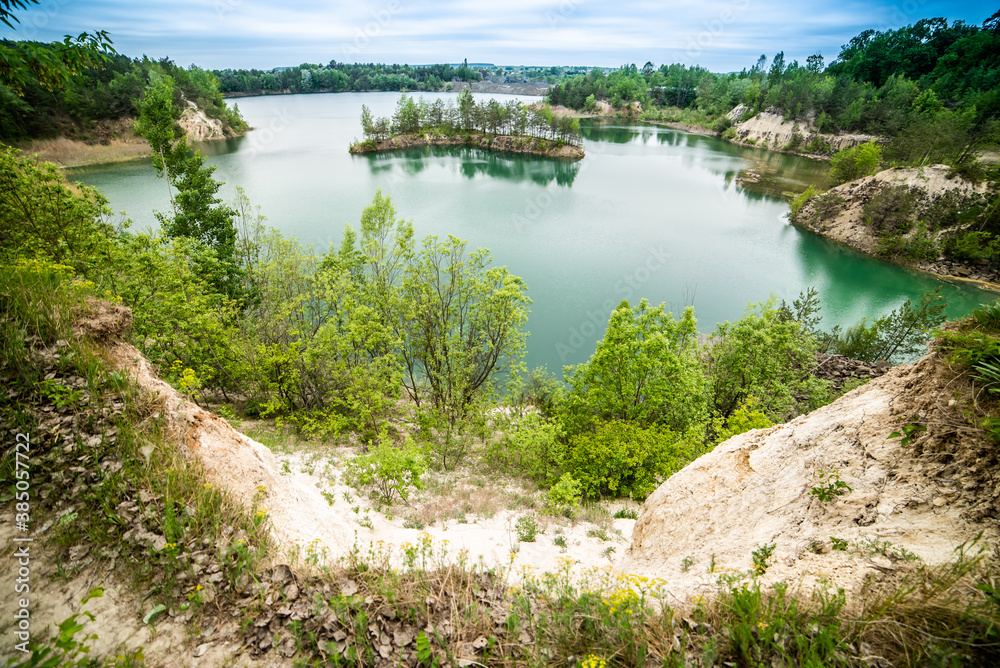 Beautiful landscape, blue lake with an island in the middle in the middle of the forest
