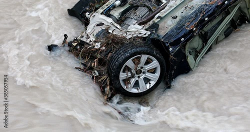Wheel Of A Destroyed Sports Car In The Roya River During Storm Alex In France, Europe. Close Up View - DCi 4K Resolution
 photo
