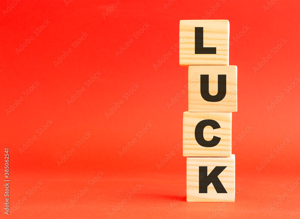 Wooden cubes with letters. Wooden cubes on a red background. Free space on the left. Wooden cubes with letters. Wooden cubes on a red background. Free space on the left.