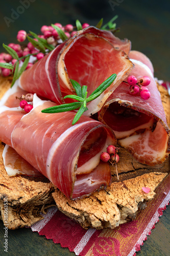 Slices of Alto Adige speck rolled with wild red pepper photo