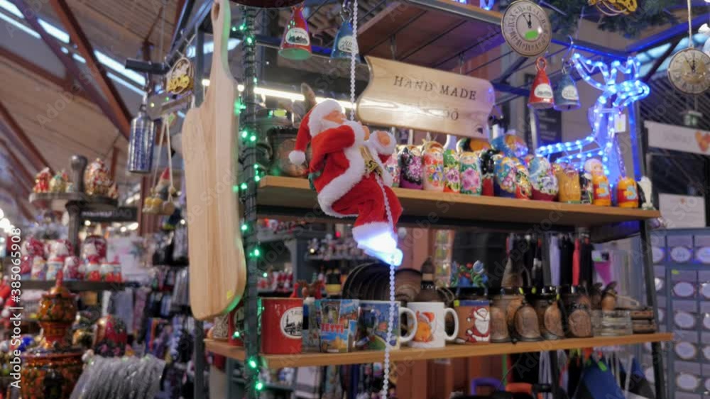 Santa Claus miniature toy is climbing on rope, on Christmas market stall Santa Claus miniature toy is climbing on rope, on Christmas market stall