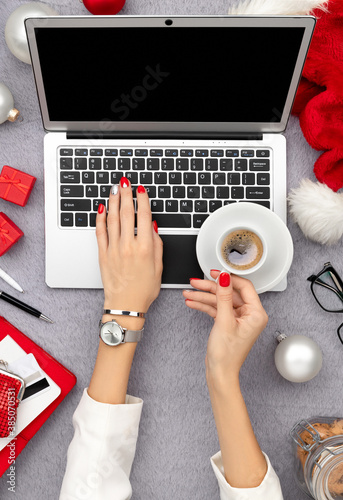 Womans hands with trendy red manicure typing on the keyboard © Darya Lavinskaya