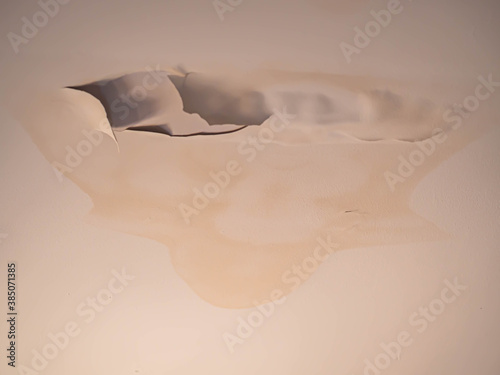 Abstract light brown background of bulging, swollen ceilling walls, Peeled and cracked paint.